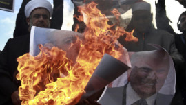 Palestinians burn posters