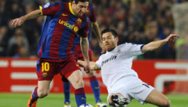 Barcelona's Lionel Messi and Real Madrid's Xabi Alonso