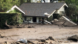 Cottages are surrounded by several feet of mud 