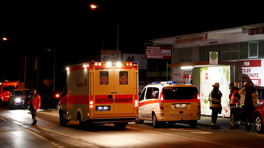 German emergency services workers work in the area where a man with an axe attacked passengers on a train near the city of Wuerzburg, Germany 