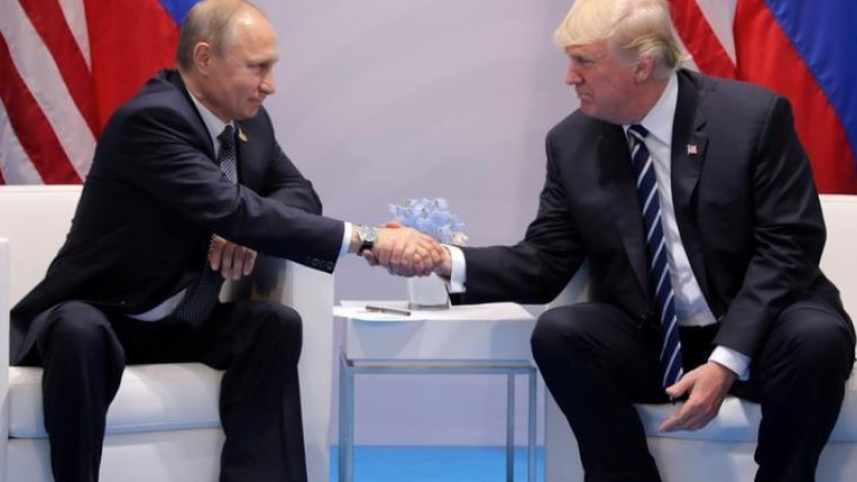 US President Donald Trump shakes hands with Russia's President Vladimir Putin 