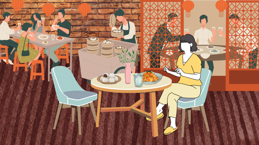 A girl eating alone at a restaurant.