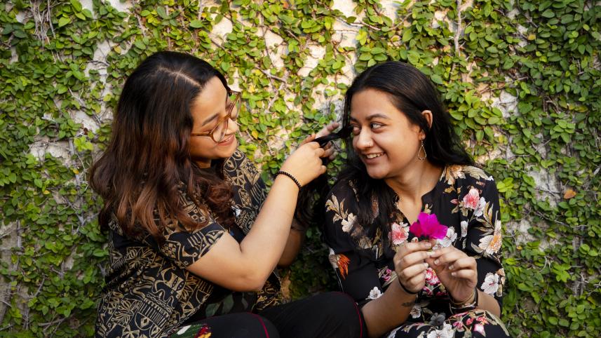 A friend braiding another friends hair.
