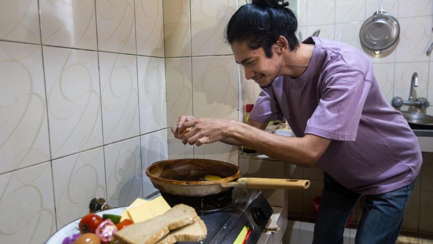 Person cooking a meal. 