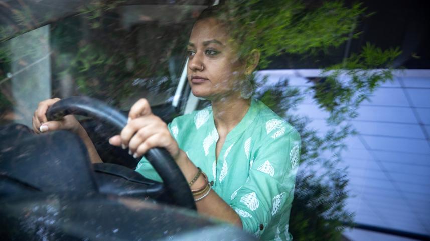a woman behind the steering wheel of a car
