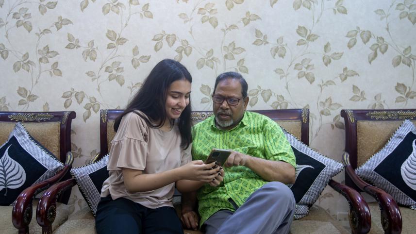 Child helping their parent figure out how to use their phone