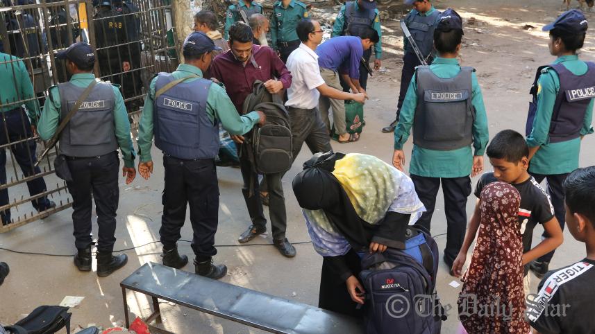 law_enforcers_check_bags_of_people_at_the_court_premises_before_the_verdict_in_the_holey_artisan_cafe_attack_case.jpg