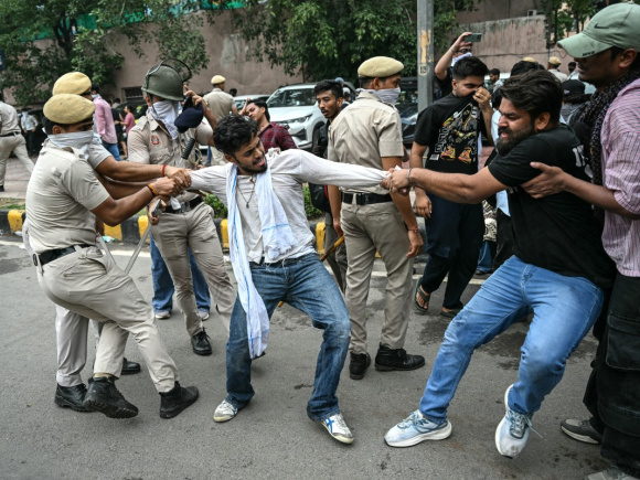 Activists and supporters of the Cockroach Janta Party (CJP) clash with police personnel during a protest demanding the resignation of India's Education Minister Dharmendra Pradhan over alleged NEET exam irregularities in New Delhi on July 20, 2026.