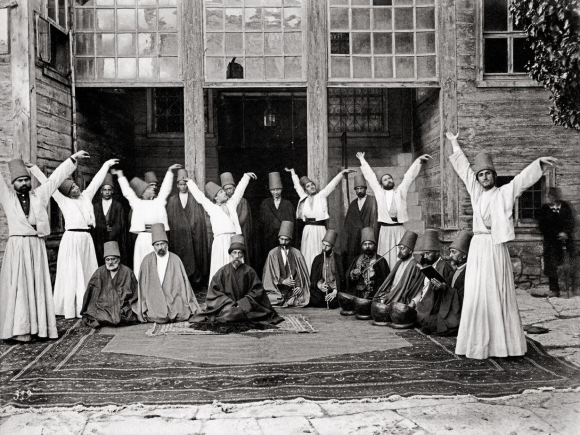 Whirling_dervishes_in_Galata_Mawlawi_House,_1870.png