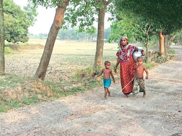 A woman in Barind region is going miles to collect water