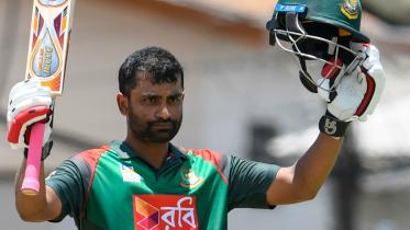 Tamim Iqbal celebrates his century during the 3rd and final ODI match between West Indies and Bangladesh