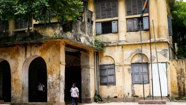 Student in front of old school building