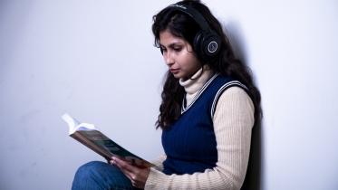 Girl listening to music while studying