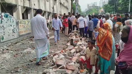 An 8ft high boundary wall suddenly gave way as a group of people, mostly women, queued beside the college for subsidised TCB goods. Photo: Star