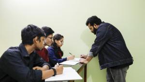 Teacher explaining a topic to his students. 